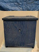 Front view of blue wooden shoe shine box showing overall condition