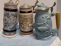 Front view of all three Avon steins