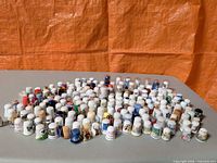 Overhead view showing full collection of thimbles spread on table