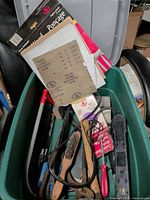 Overall view inside tote showing sandpaper packs and various tools