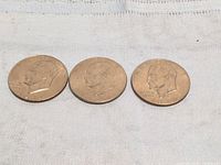 Three Eisenhower dollar coins obverse view