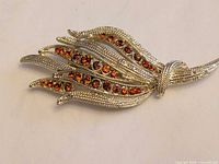 front view showing rhinestones and leaf design