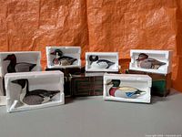 Group view of seven boxed Avon duck figurines