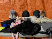 Full lot laid out showing hats, mittens, gloves, scarves