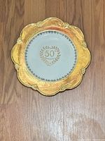 Front view showing gold gilt rim and 50th Anniversary centre design