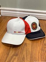 Two caps: white/red Neff Golf and navy/white Carlisle Golf & Country Club