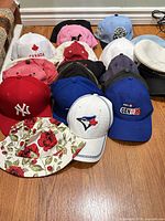 Front view showing multiple baseball caps and floral bucket hat