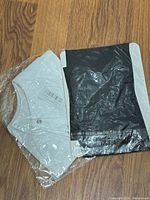 White detachable collar in clear plastic and black pantyhose package