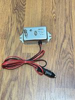 Full view of Diesel 4-701 amplifier with power lead and lighter plug