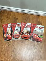 Front covers of all four Cars activity workbooks