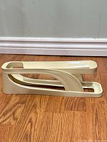 Side view of beige plastic egg holder