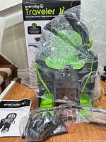 Bike seat in plastic wrap with mounting hardware, manual and box visible