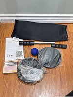 Full set laid out including bar, sliders, ball, resistance band box, manual, bag