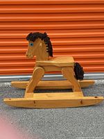 Full side view of wooden rocking horse
