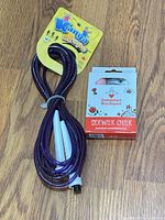 Jump rope coiled beside unopened box of sidewalk chalk