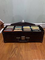 Closed brown case open to display tapes
