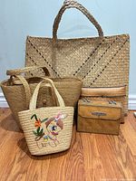 Group shot of five straw and rattan bags