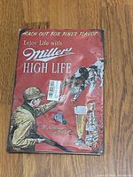 Front of Miller High Life metal sign showing artwork and wear