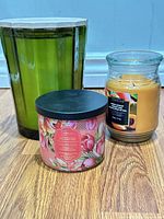 All three candles together showing relative sizes and containers