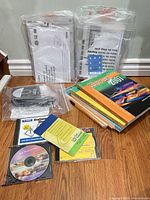 Group shot showing all workbooks, sealed manuals, and software discs