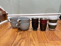 Group shot of all ten pieces lined up on wood floor