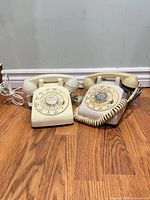 Front view of both rotary telephones side by side showing overall condition