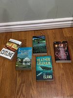 Front covers of all five paperback novels arranged face up on floor