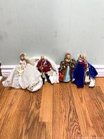 Group of four Peggy Nisbet dolls standing