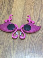 Front view folded sunglasses showing flamingo glitter frames and lenses