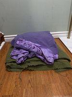 Stacked purple and olive virgin wool blankets showing overall appearance and colors