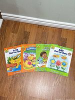 Front covers of four School Zone workbooks