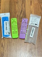 All three silicone remote covers displayed: blue (sealed), green, purple
