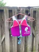 Full view of vest on hanger showing front zipper and overall design