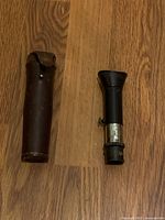 monocular alongside leather case