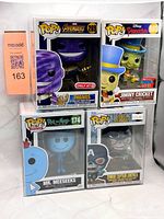 Front view of four boxed Funko Pop figures in protectors
