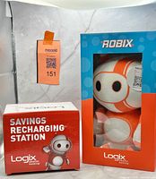 Front view showing Robix plush in blue window box and red Savings Recharging Station box