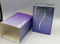 Front view of sealed perfume box and outer sleeve