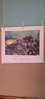 Full view of lithograph hung by clips