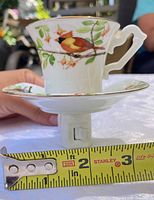 Side view of night light showing bird design and measuring tape for height