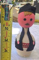 Front view with ruler showing height and fabric doll details