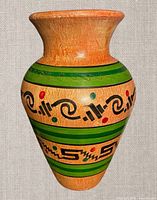 Full front view of hand-painted terracotta vase showing pattern and shape