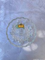 Top view showing starburst pattern, scalloped rim and brand sticker