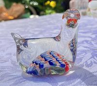 Full view of clear glass bird paperweight showing millefiori decoration