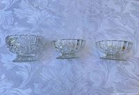 overview of three clear pressed-glass dessert bowls