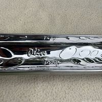 Embossed Olive Tray text and olive motif on polished stainless surface