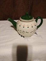 Side view of teapot showing pattern and lid