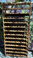 Front view of full wooden wine rack showing all tiers