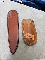 Front view of both sheaths showing leather type and size difference