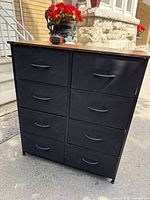 Front view of dresser showing eight black cloth drawers and wood top