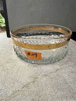 Full view of glass bowl showing gold band and faceted base